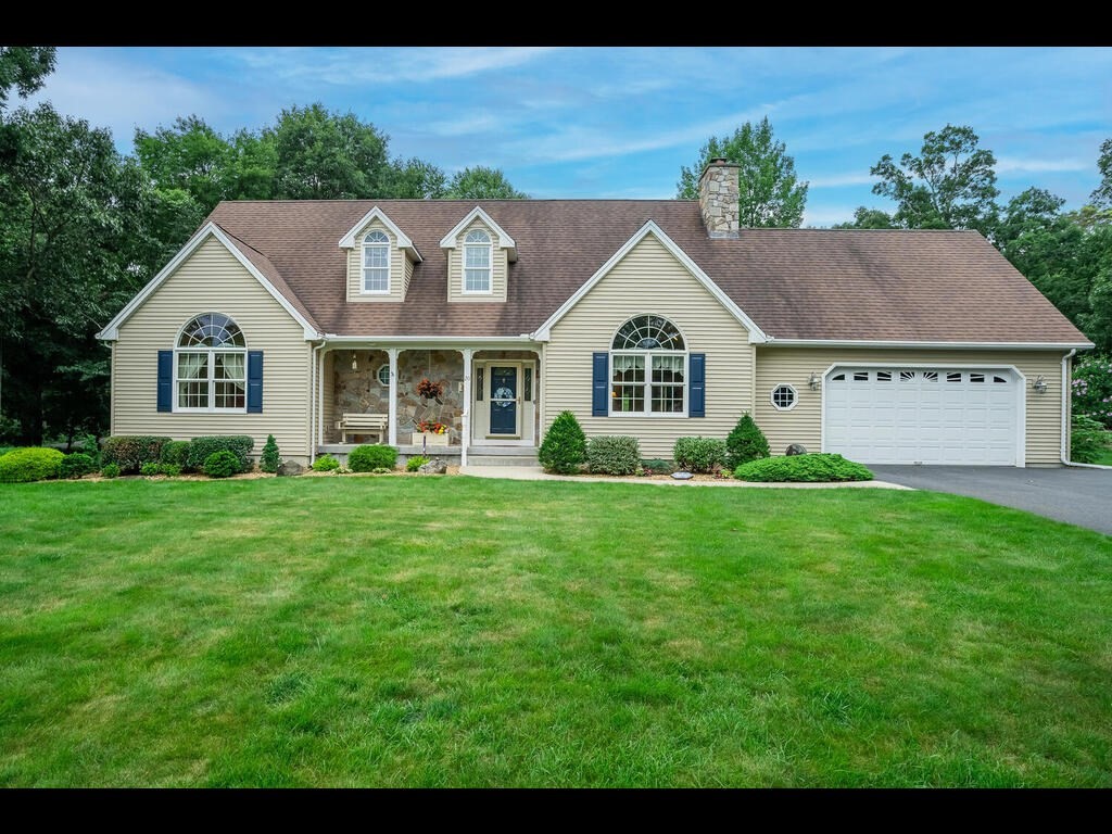 20 Paradise Lake Road Monson, MA 01057 - Photo 1 of 42 a front view of a house with a garden