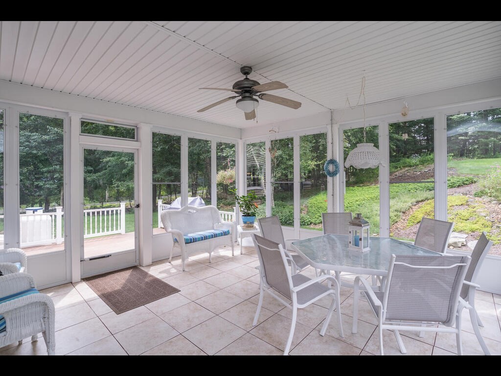 20 Paradise Lake Road Monson, MA 01057 - Photo 13 of 42 a living room with furniture and large windows