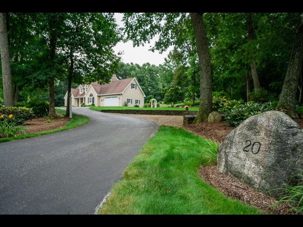 20 Paradise Lake Road Monson, MA 01057 - Photo 2 of 42 a view of a street with a fountain and large trees