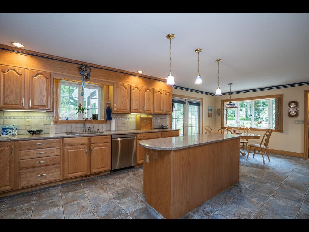 20 Paradise Lake Road Monson, MA 01057 - Photo 23 of 42 a kitchen with stainless steel appliances granite countertop a sink a stove and a wooden floors