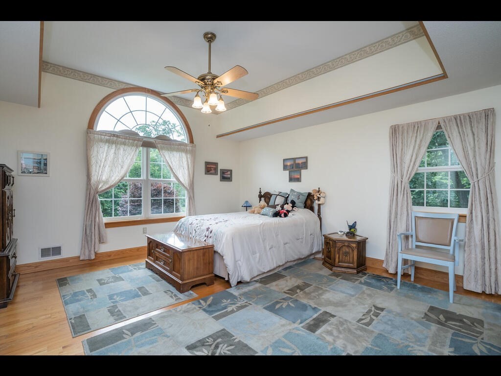 20 Paradise Lake Road Monson, MA 01057 - Photo 29 of 42 a bed sitting in a spacious bedroom next to a window