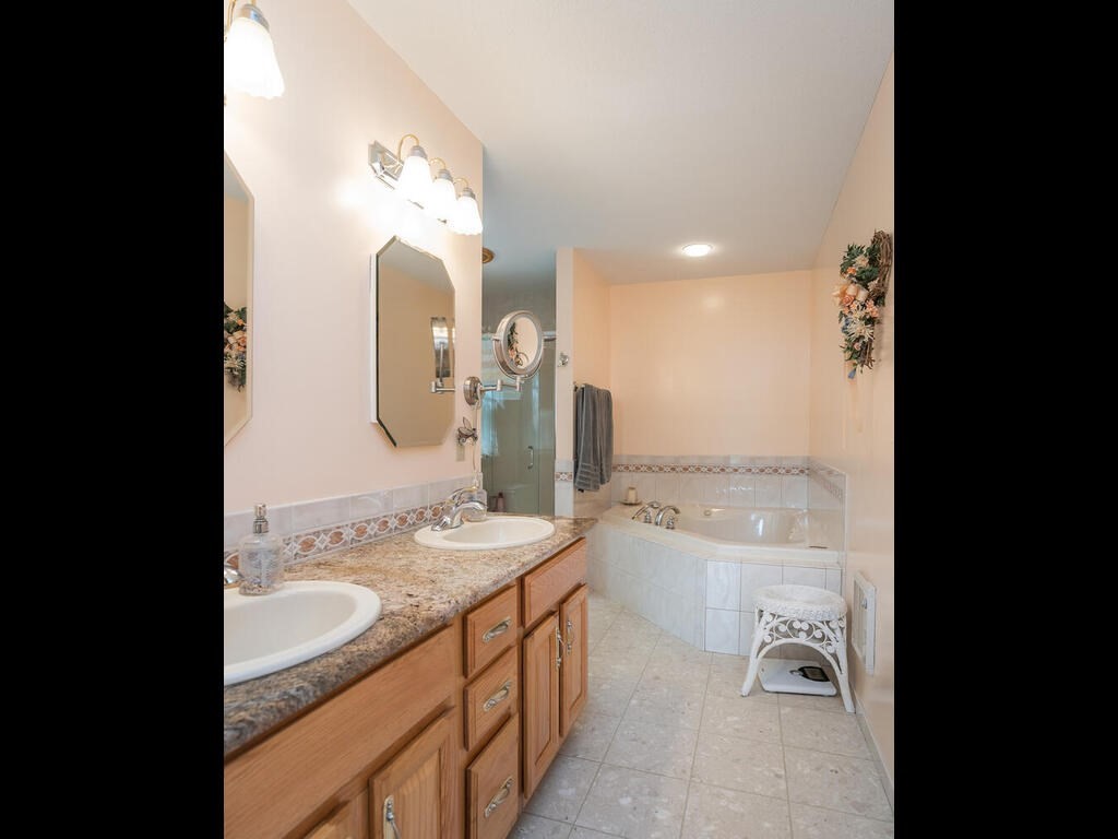 20 Paradise Lake Road Monson, MA 01057 - Photo 32 of 42 a bathroom with a double vanity sink and a mirror
