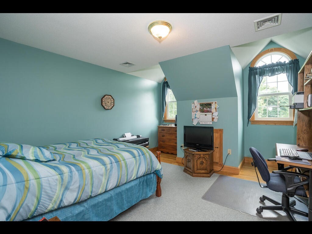 20 Paradise Lake Road Monson, MA 01057 - Photo 34 of 42 a bedroom with a bed and chair