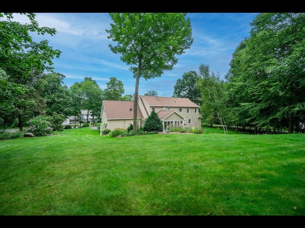 20 Paradise Lake Road Monson, MA 01057 - Photo 4 of 42 a view of a big house with a big yard and large trees