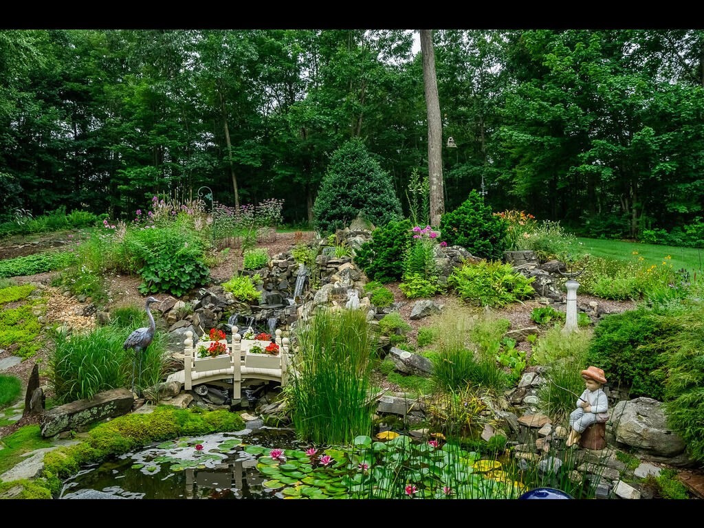 20 Paradise Lake Road Monson, MA 01057 - Photo 8 of 42 a view of a garden with plants and large trees