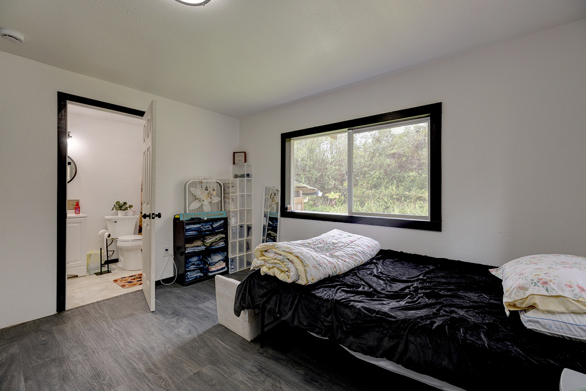 18-1248 Thorne Parkway Mountain View, HI 96771 - Photo 16 of 25 a bedroom with a bed and wooden floor