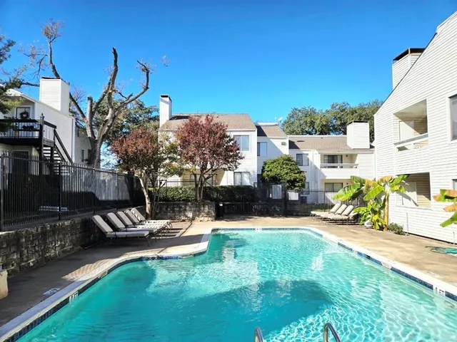 a view of a house with a yard patio and fire pit