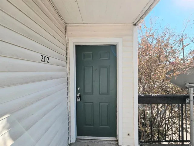 a view of a door and wooden floor