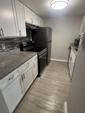 a kitchen with a refrigerator and a sink