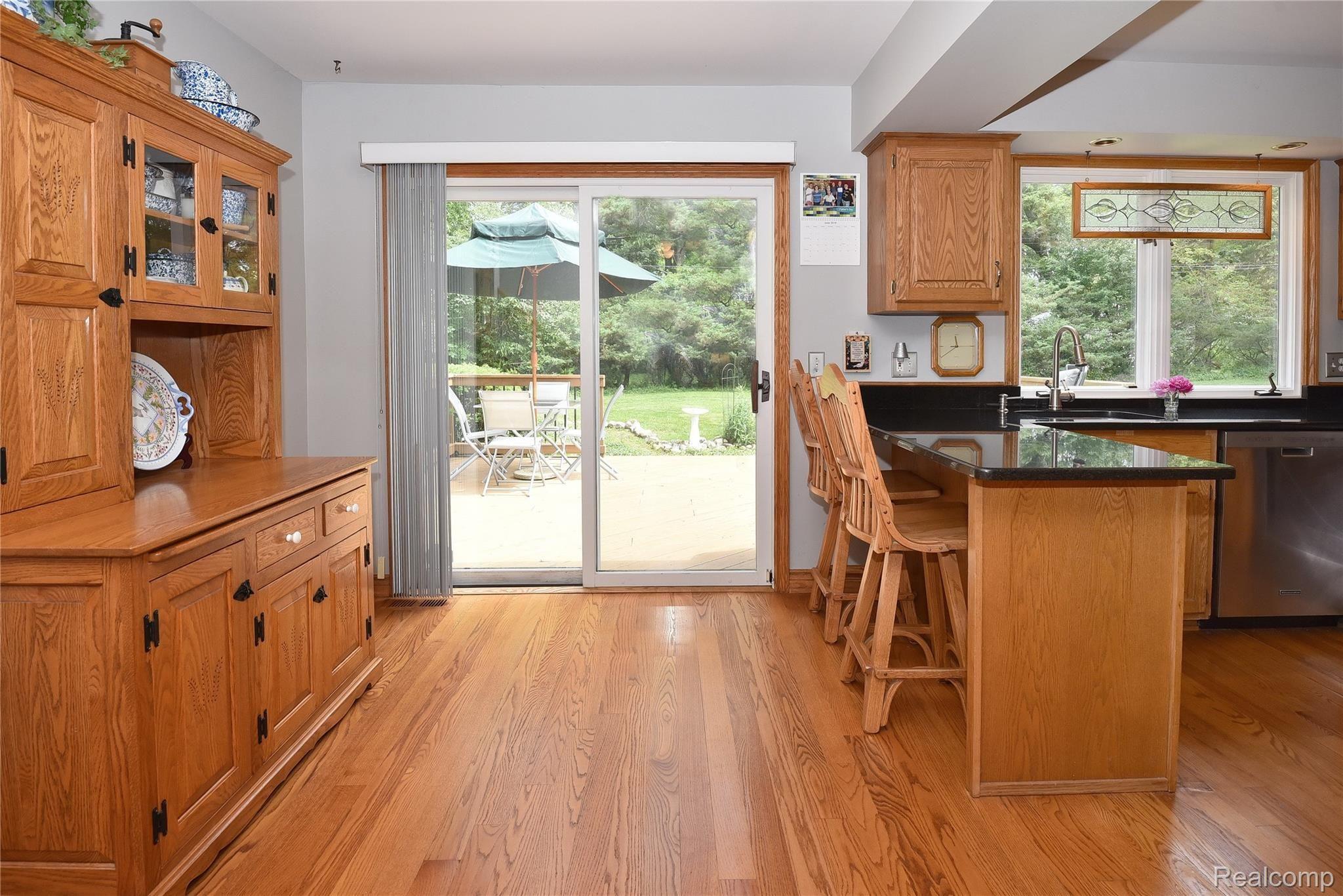 2962 Mohawk Lane Rochester, MI 48306 - Photo 5 of 28 Extended Kitchen w/ seating and sliding door to 280 sq ft deck