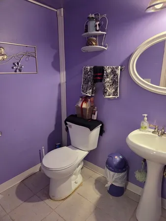a bathroom with a toilet sink and mirror