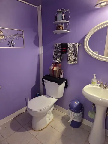 a bathroom with a toilet sink and mirror