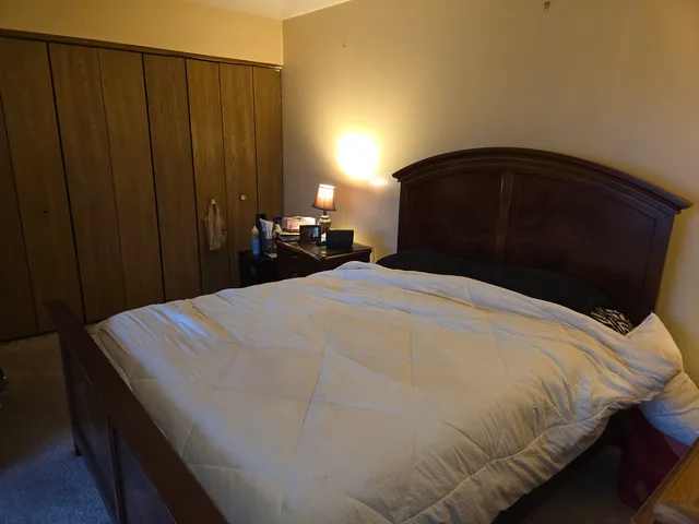 a bedroom with a bed and a night stand