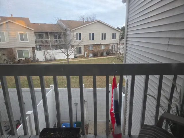 a view of a house with wooden fence