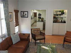 a living room with furniture and painting on the wall