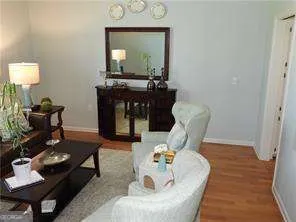 a living room with furniture and a mirror