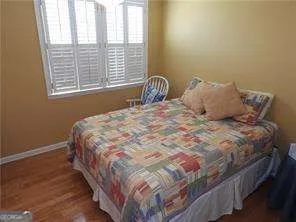 a large bed sitting in a bedroom next to a window