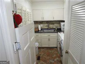 a kitchen with a sink and a stove next to a window