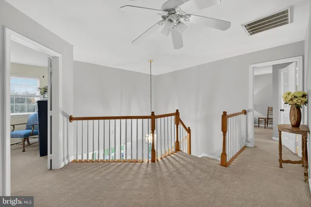 a view of a house with wooden deck and furniture