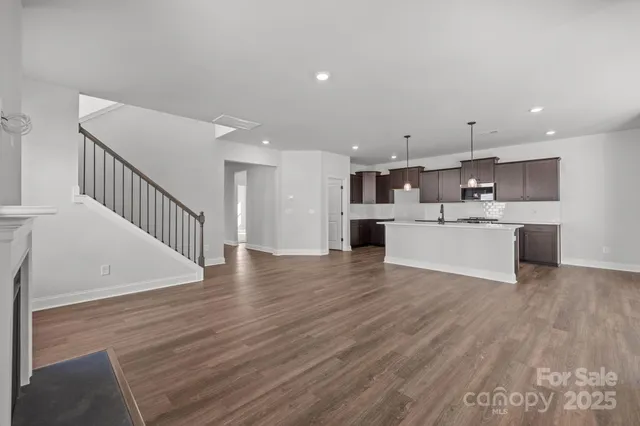 a view of kitchen with wooden floor and electronic appliances