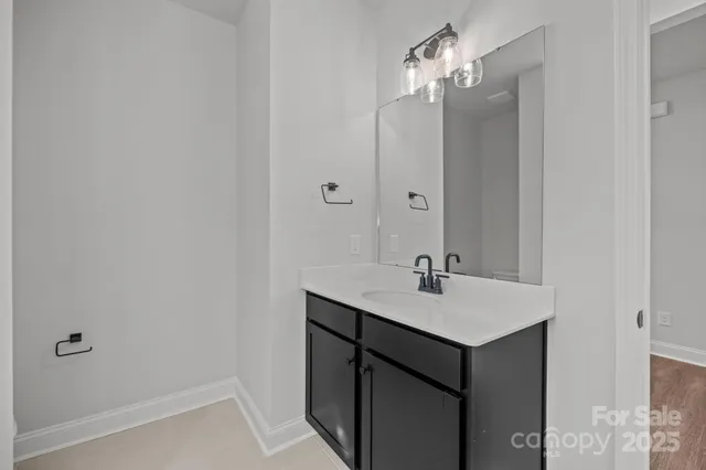 a bathroom with a sink vanity and a mirror