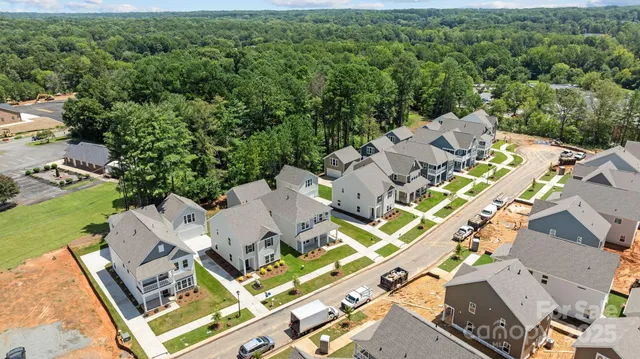 an aerial view of a residential apartment building with a yard and balcony