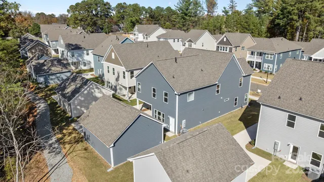 an aerial view of a house with a yard