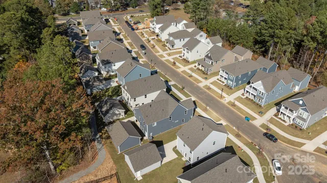 an aerial view of a house with yard and outdoor seating