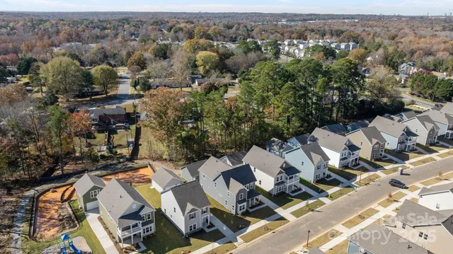 an aerial view of a house with a yard