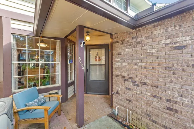 a front view of a house with outdoor seating