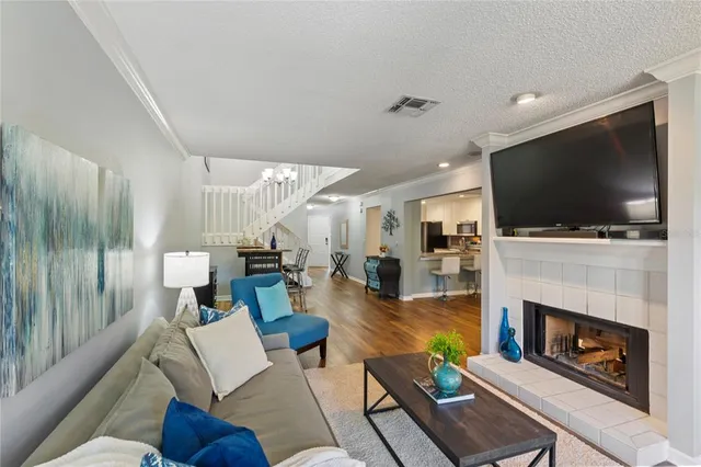 a living room with furniture a flat screen tv and a fireplace