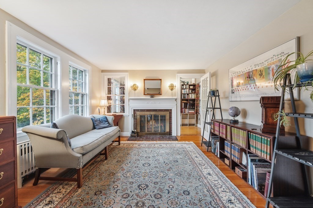 74 Middle Street Lexington, MA 02421 - Photo 5 of 37 a living room with furniture a fireplace and a large window