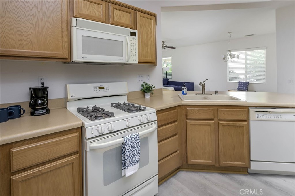 9141 Filaree Court Corona, CA 92883 - Photo 12 of 54 a kitchen with a sink stove and cabinets
