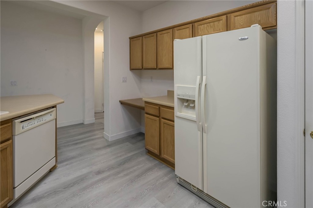 9141 Filaree Court Corona, CA 92883 - Photo 13 of 54 a white refrigerator freezer sitting inside of a kitchen