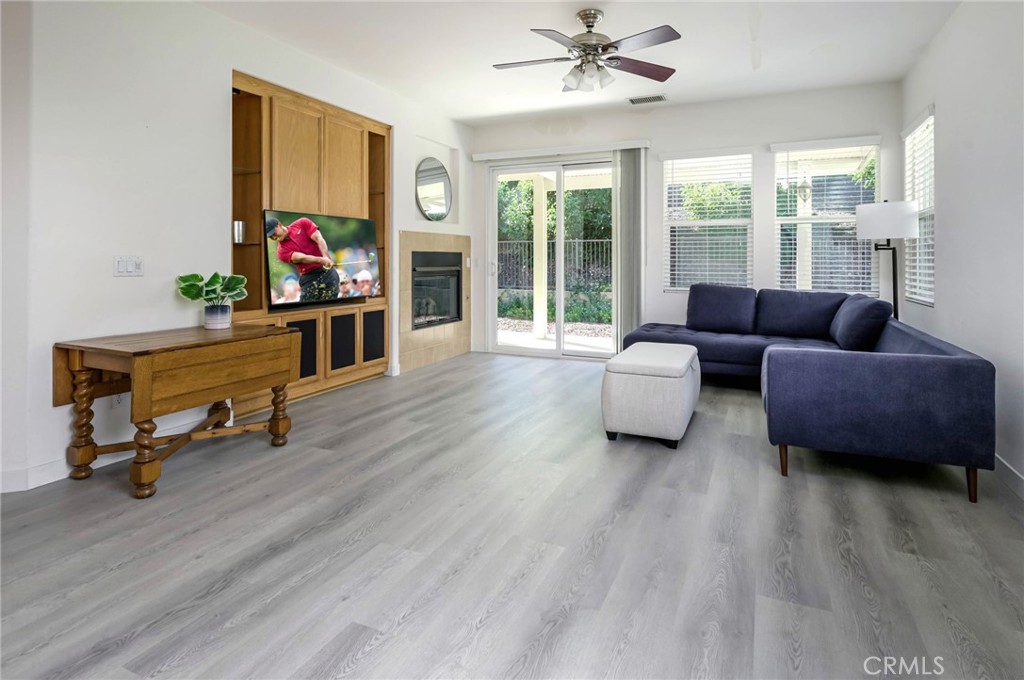 9141 Filaree Court Corona, CA 92883 - Photo 15 of 54 a living room with furniture and a flat screen tv