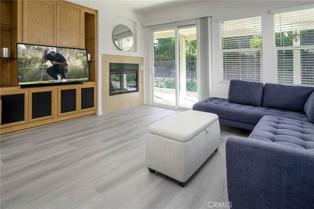 9141 Filaree Court Corona, CA 92883 - Photo 16 of 54 a living room with furniture and a fireplace