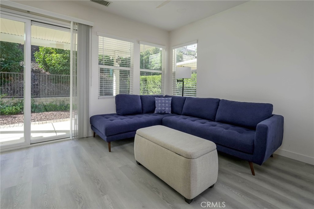 9141 Filaree Court Corona, CA 92883 - Photo 18 of 54 a living room with furniture and a large window