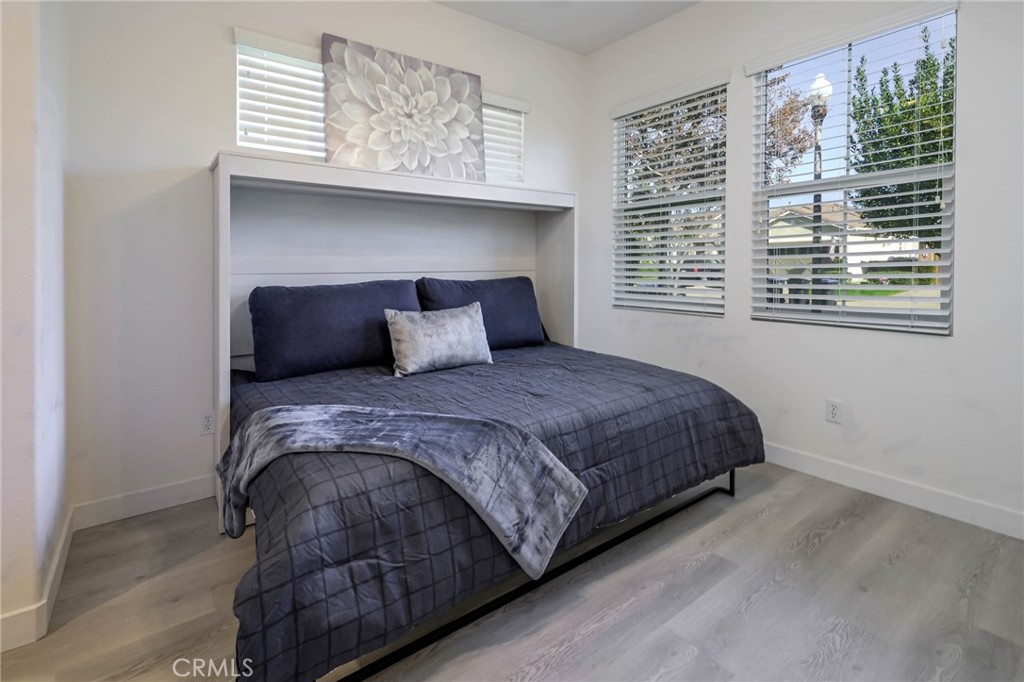 9141 Filaree Court Corona, CA 92883 - Photo 27 of 54 a bedroom with a bed and windows