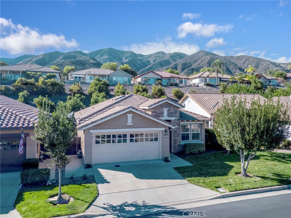 9141 Filaree Court Corona, CA 92883 - Photo 3 of 54 a view of a house with a yard and a garden