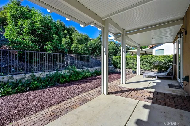 a view of a patio with a table chairs and a backyard