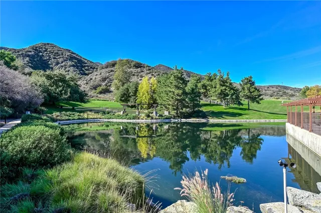 a dining room with wooden floor a glass table and chairs