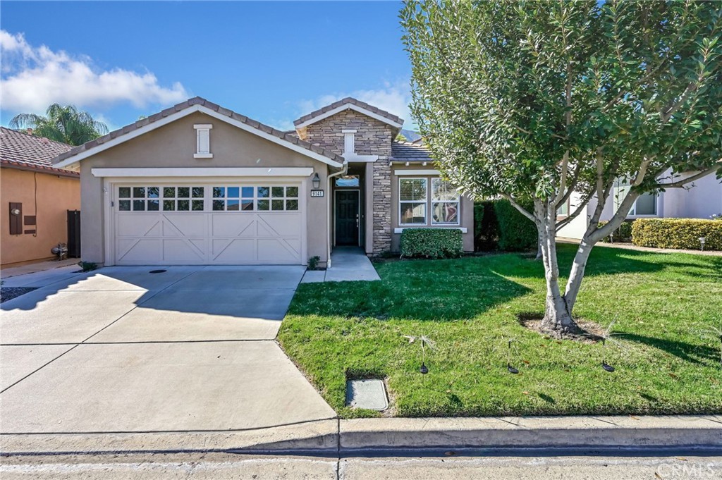 9141 Filaree Court Corona, CA 92883 - Photo 4 of 54 a front view of a house with garden