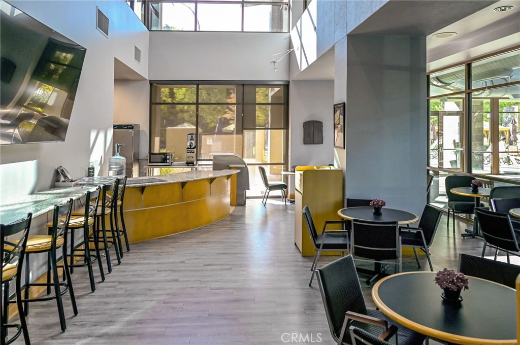 9141 Filaree Court Corona, CA 92883 - Photo 41 of 54 a dining room with wooden floor a glass table and chairs