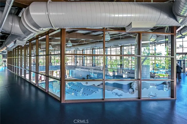 a balcony with wooden floor next to a yard
