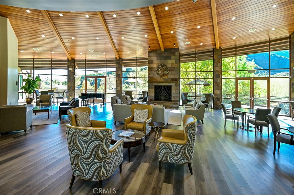 9141 Filaree Court Corona, CA 92883 - Photo 47 of 54 a dining room with furniture large windows and wooden floor