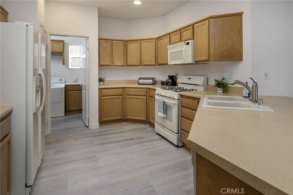 9141 Filaree Court Corona, CA 92883 - Photo 8 of 54 a kitchen with a sink cabinets and stainless steel appliances
