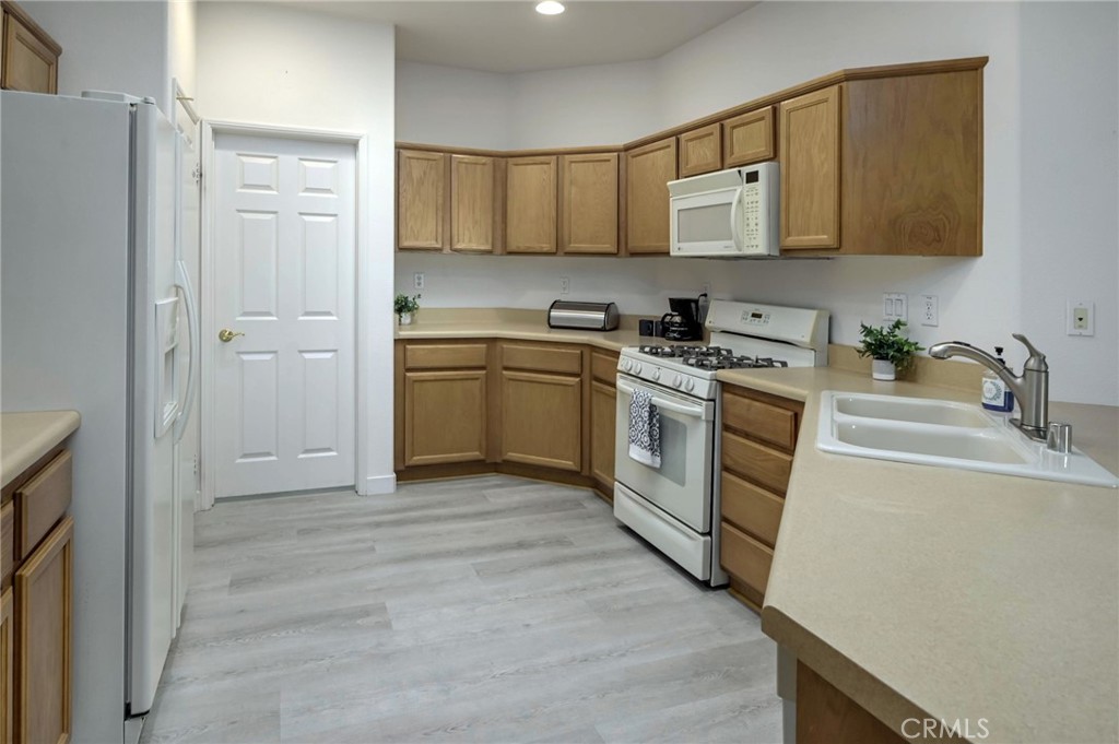 9141 Filaree Court Corona, CA 92883 - Photo 9 of 54 a kitchen with a sink and a stove top oven