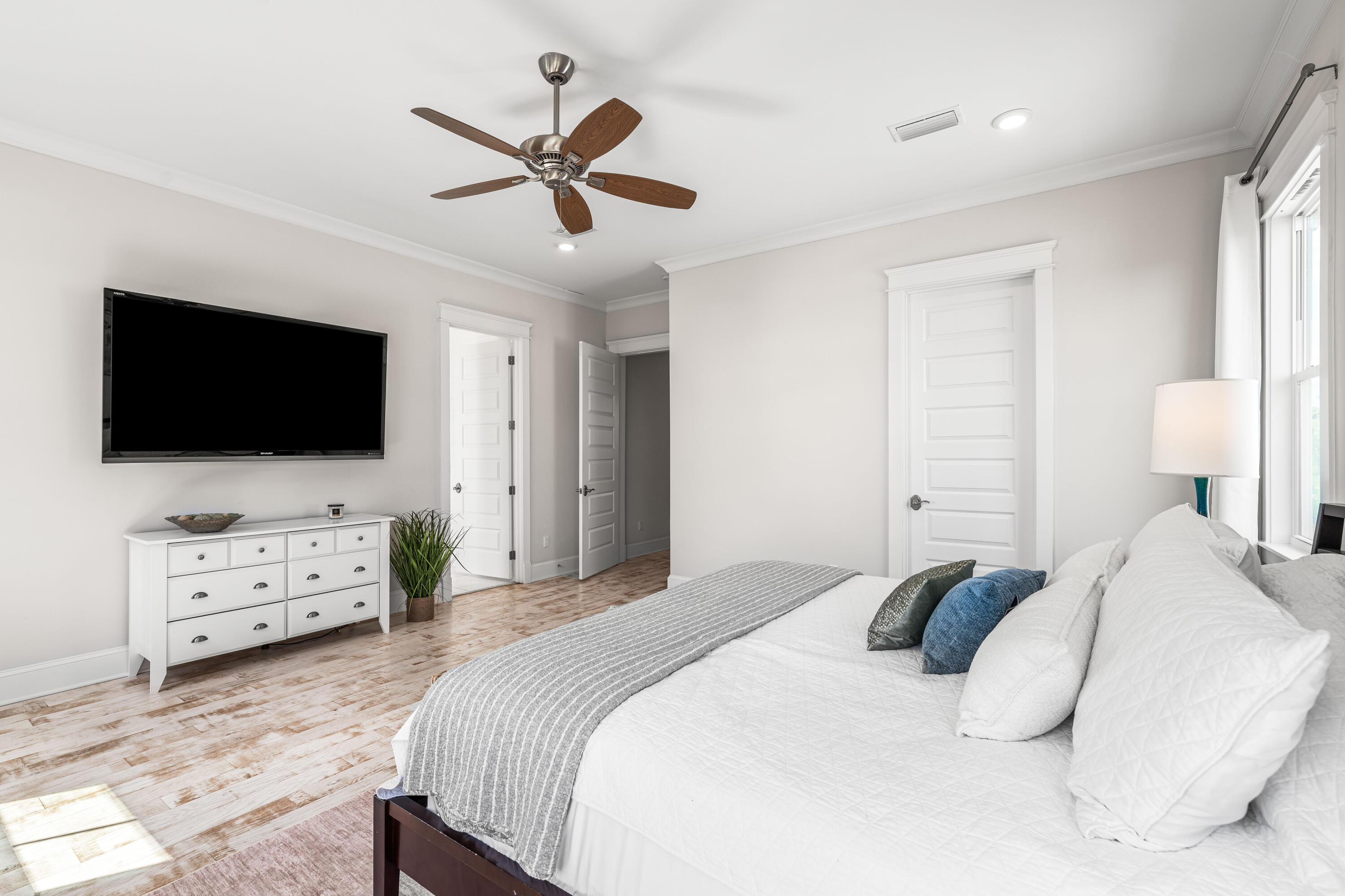 164 Clipper Street Inlet Beach, FL 32461 - Photo 49 of 75 a bedroom with a bed window tv and wooden floor