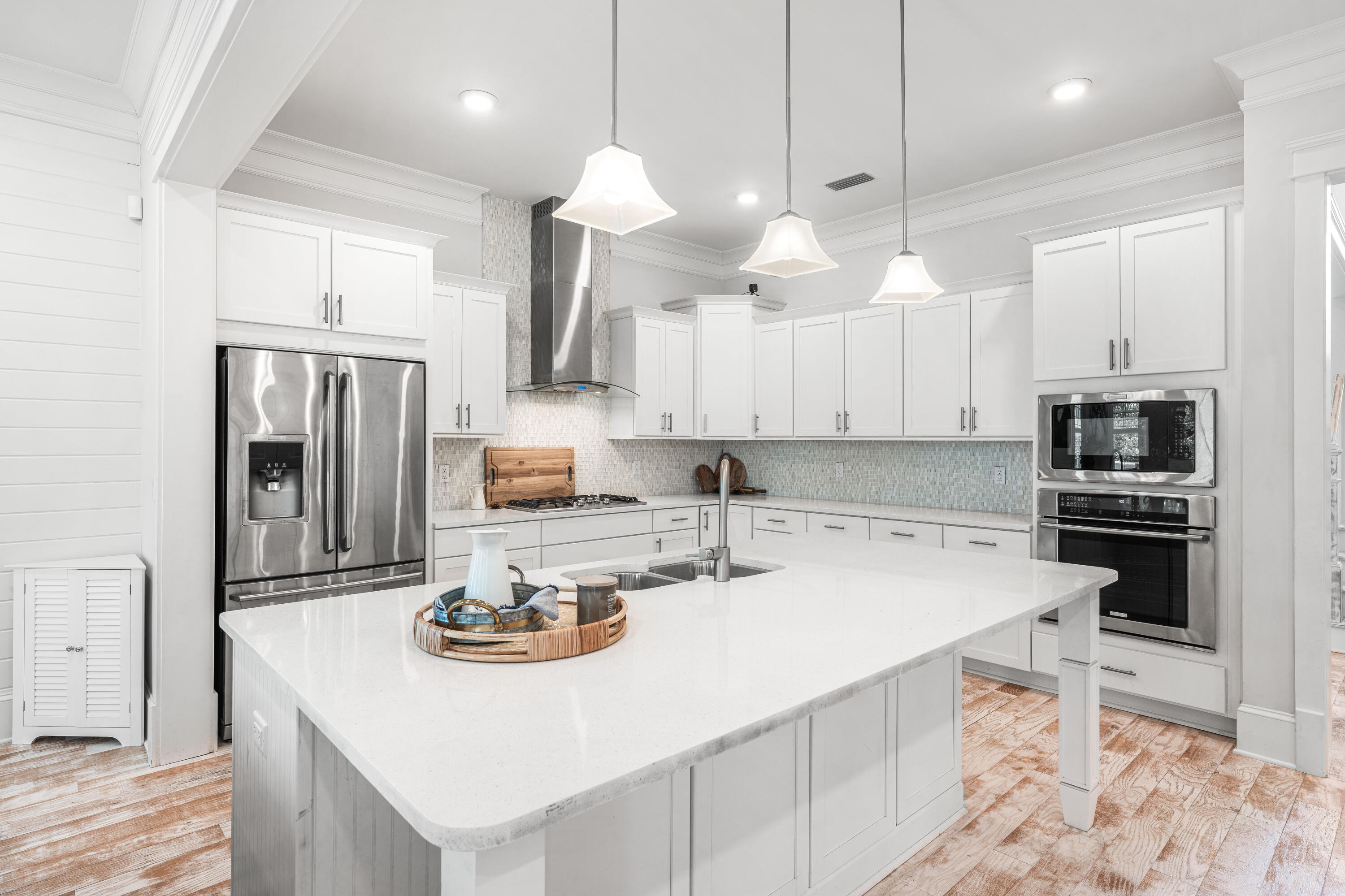 164 Clipper Street Inlet Beach, FL 32461 - Photo 7 of 75 a kitchen with a sink a stove a refrigerator and white cabinets with wooden floor