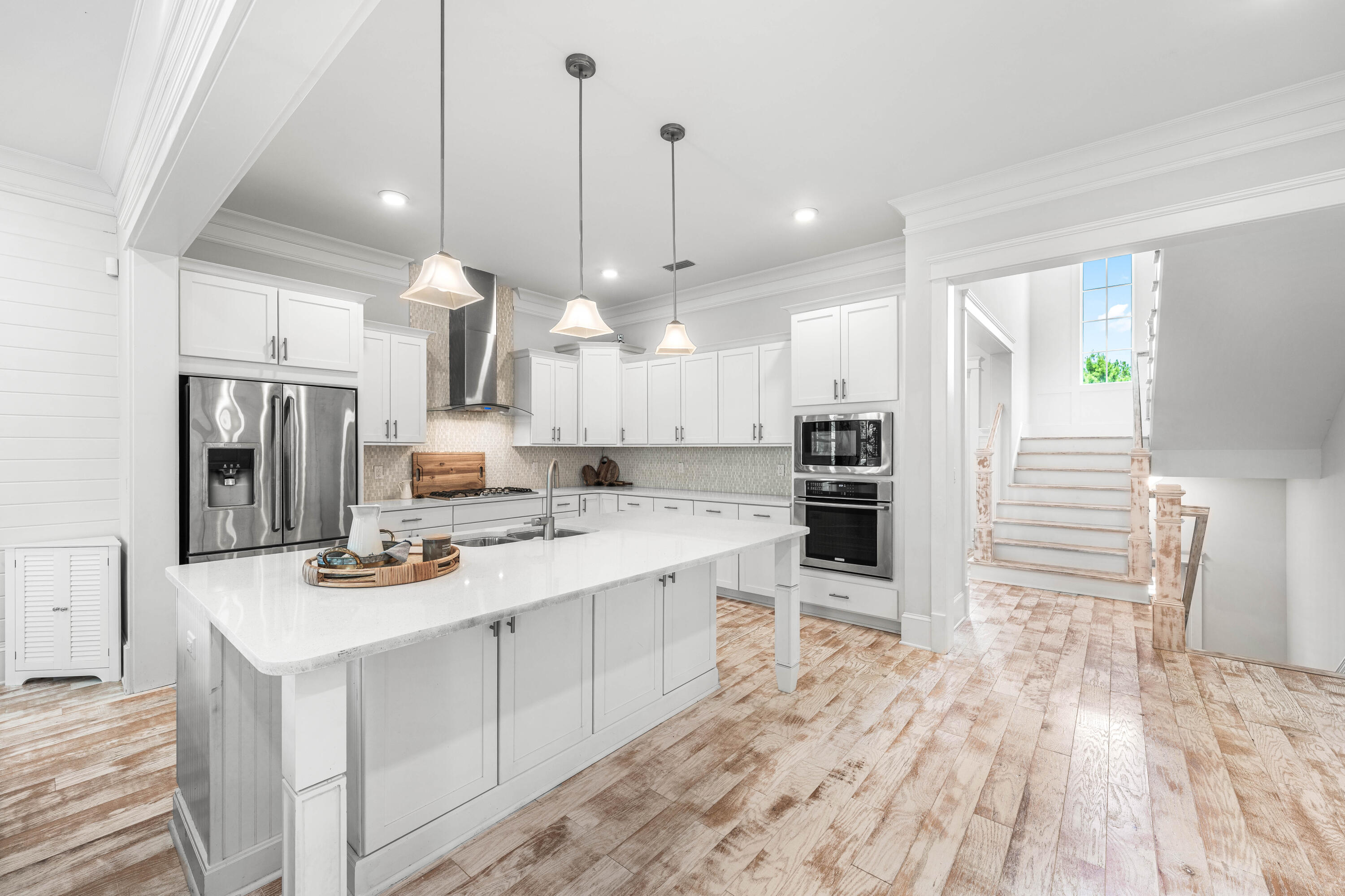 164 Clipper Street Inlet Beach, FL 32461 - Photo 8 of 75 a large kitchen with kitchen island a refrigerator a stove a sink dishwasher a dining table and chairs with wooden floor